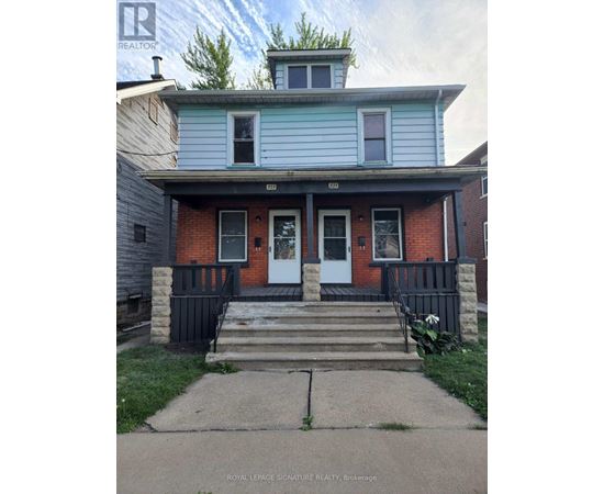 A blue house with a white door and windows.