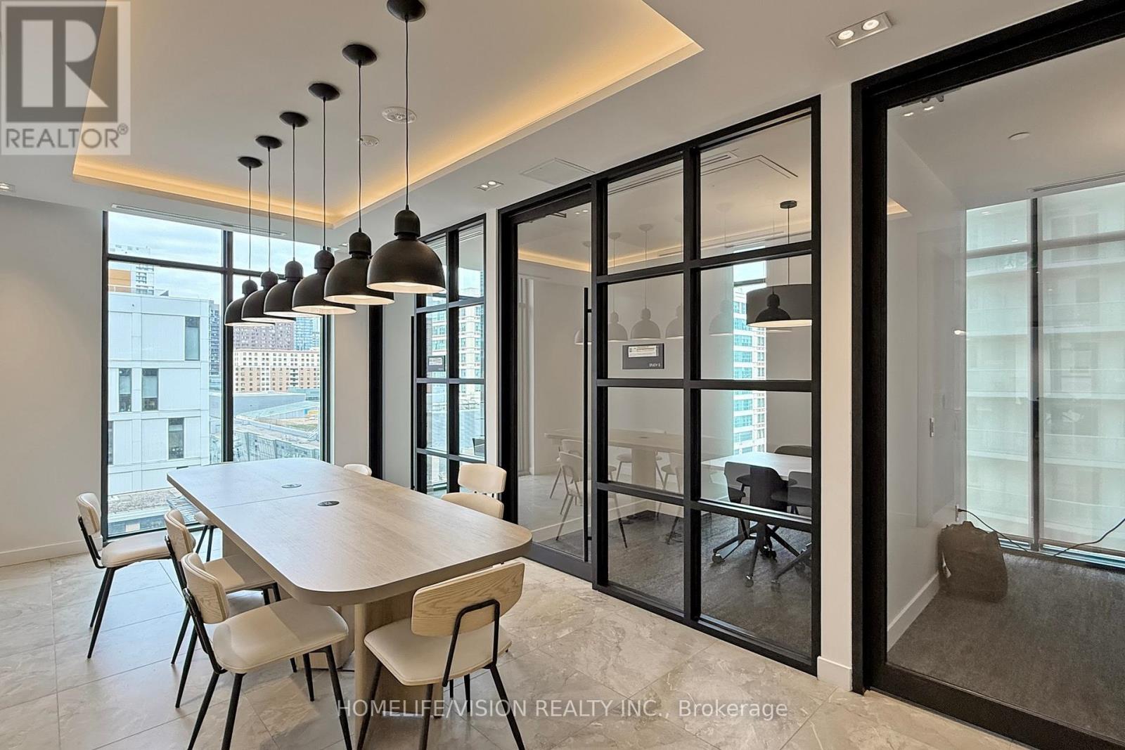 A modern dining room with a large table and chairs.