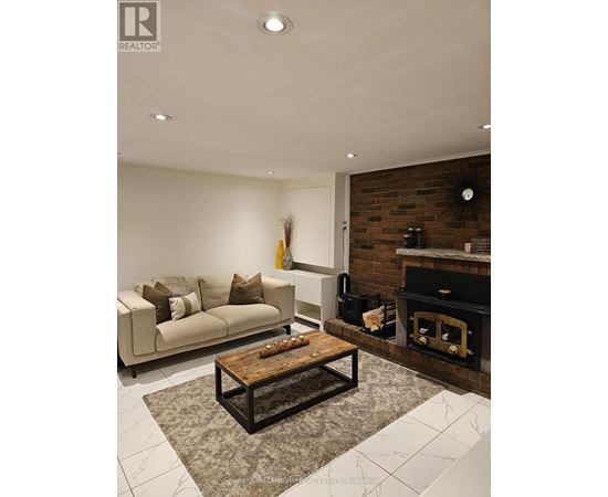 A living room with a fireplace and a couch.