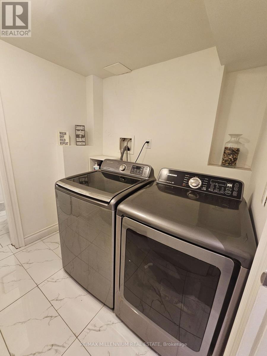 A kitchen with two ovens and a microwave.