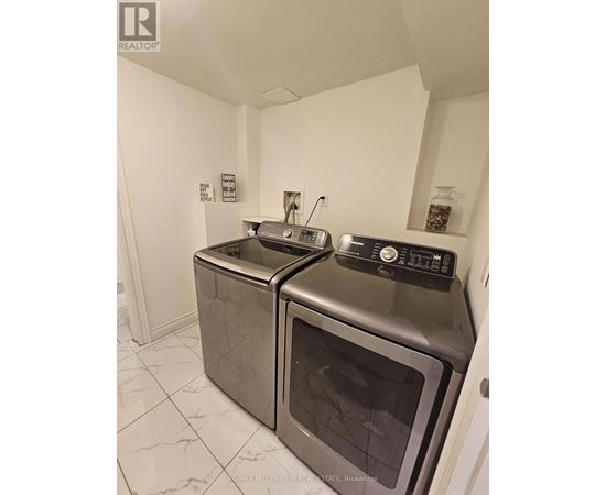 A kitchen with two ovens and a microwave.