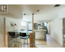 A modern kitchen with a glass table and chairs.