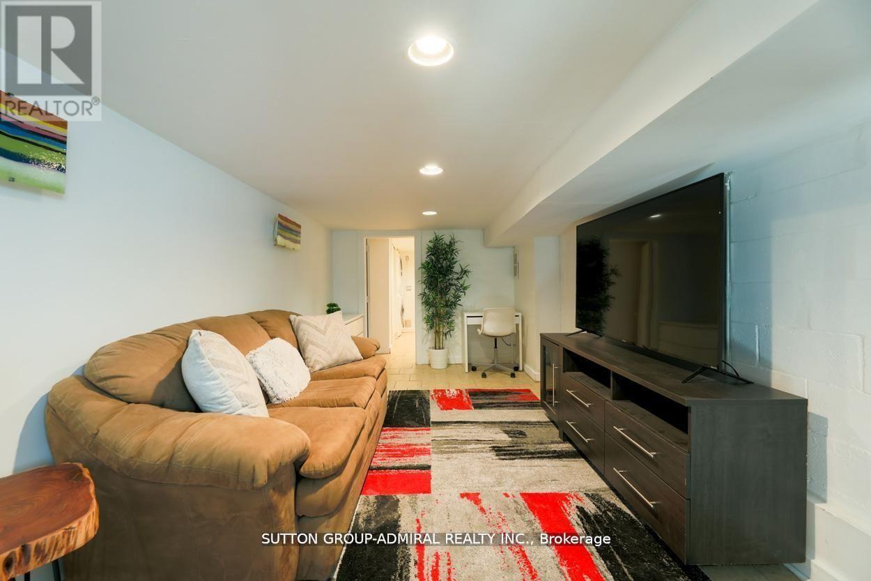 A living room with a brown couch and a flat screen TV.