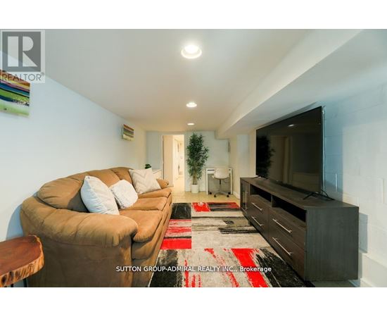A living room with a brown couch and a flat screen TV.