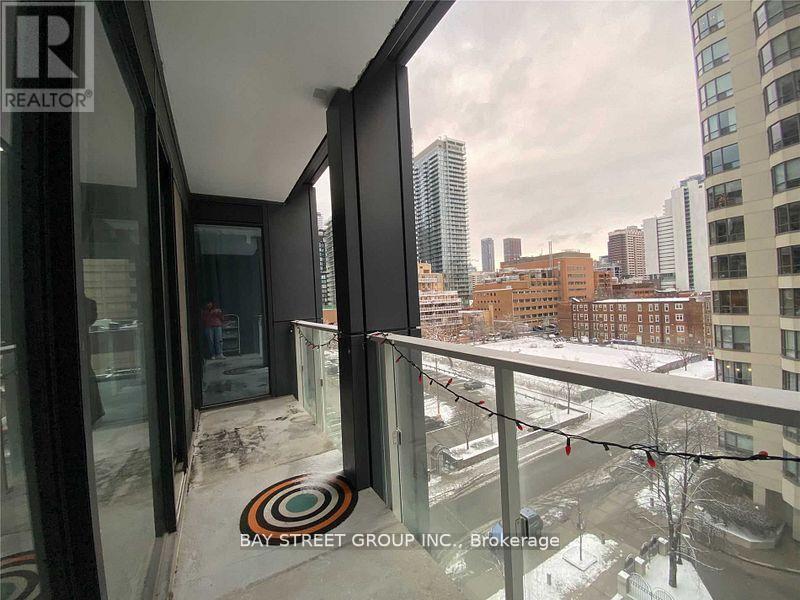 A view from a window of a cityscape with buildings and a bay street group inc brokerage sign.