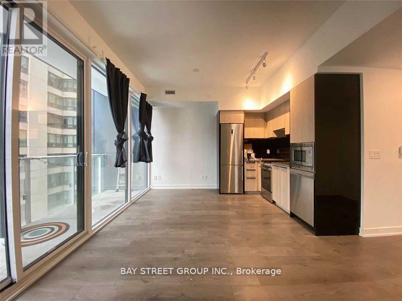 A spacious kitchen with a refrigerator, oven, and sink.