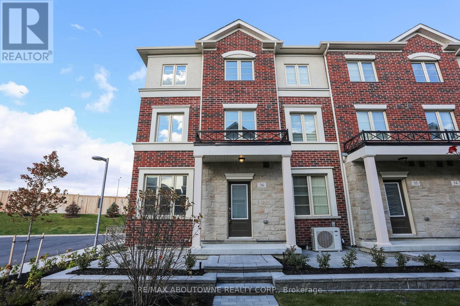 A multi-story residential building with a balcony on the second floor.