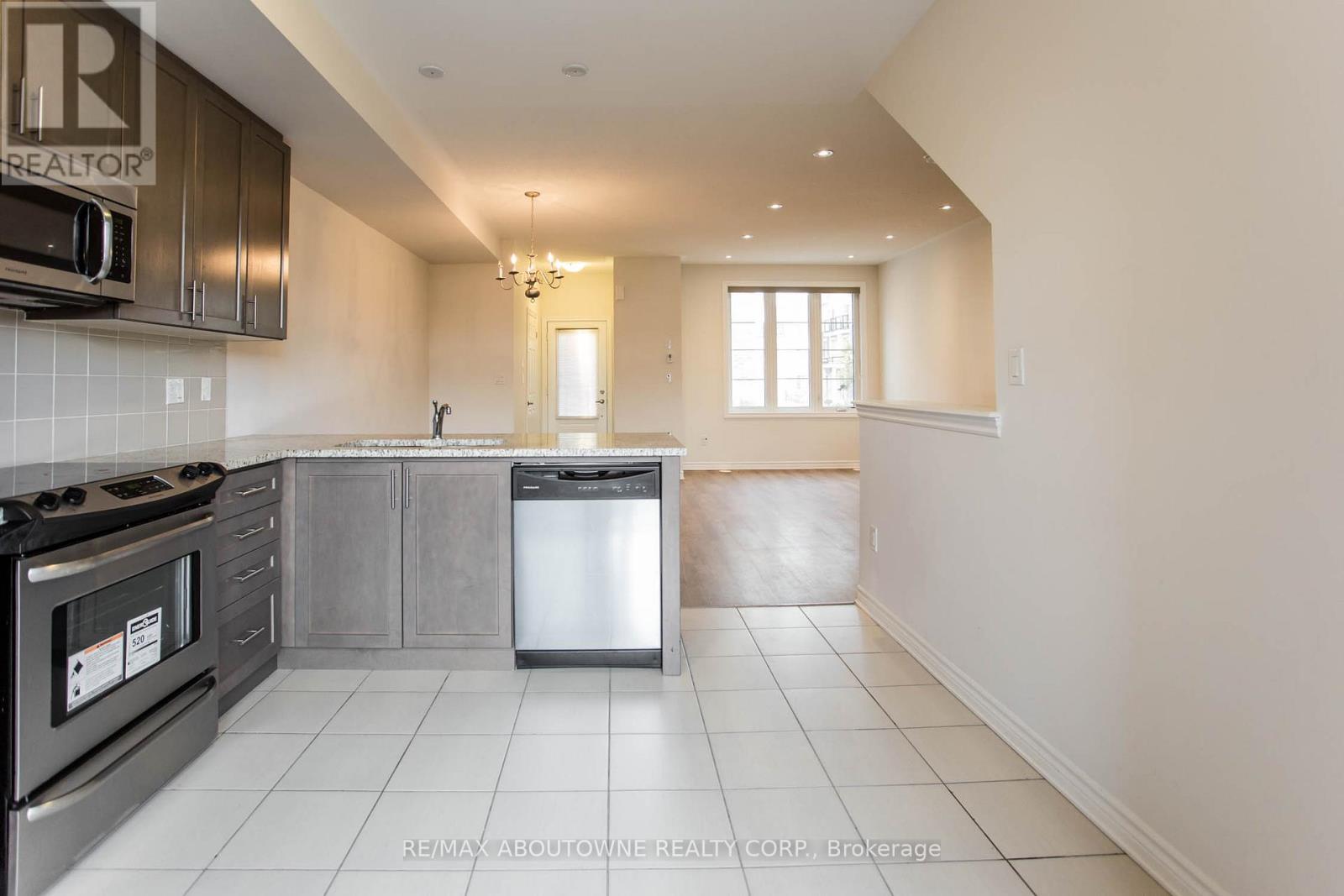 A kitchen with a stove top oven and a dishwasher.