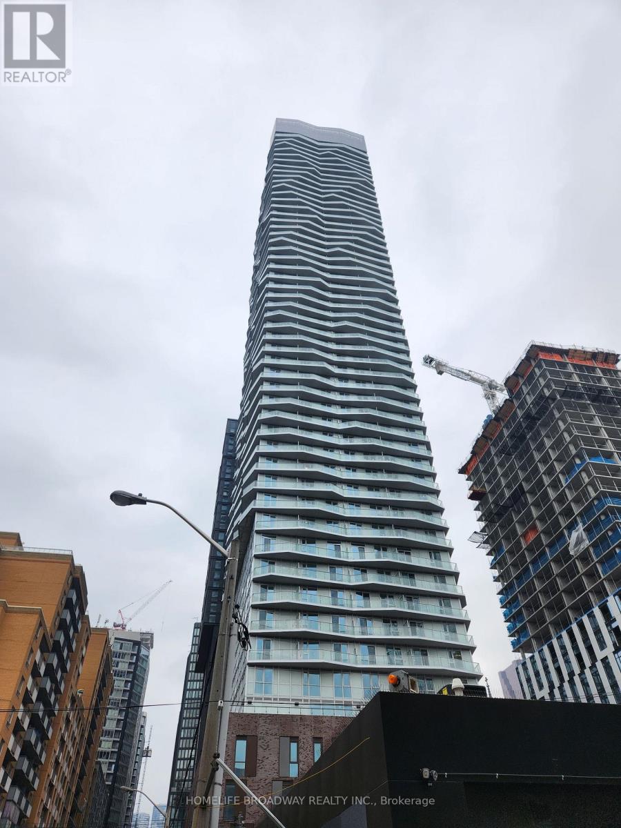 A tall building under construction with a crane on the right side.