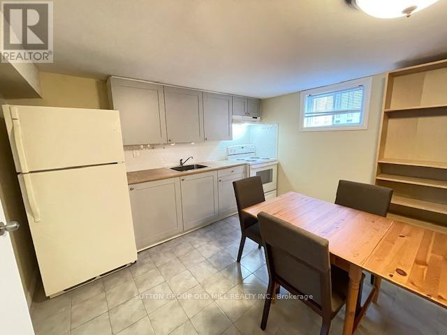A kitchen with a table and chairs.