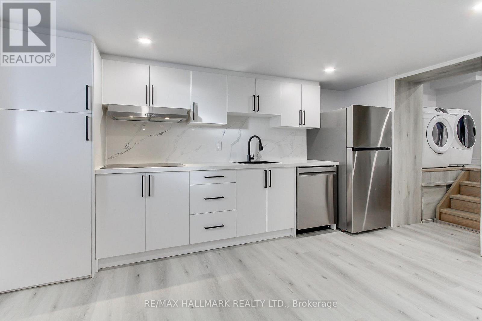 A modern kitchen with a glass table and chairs.