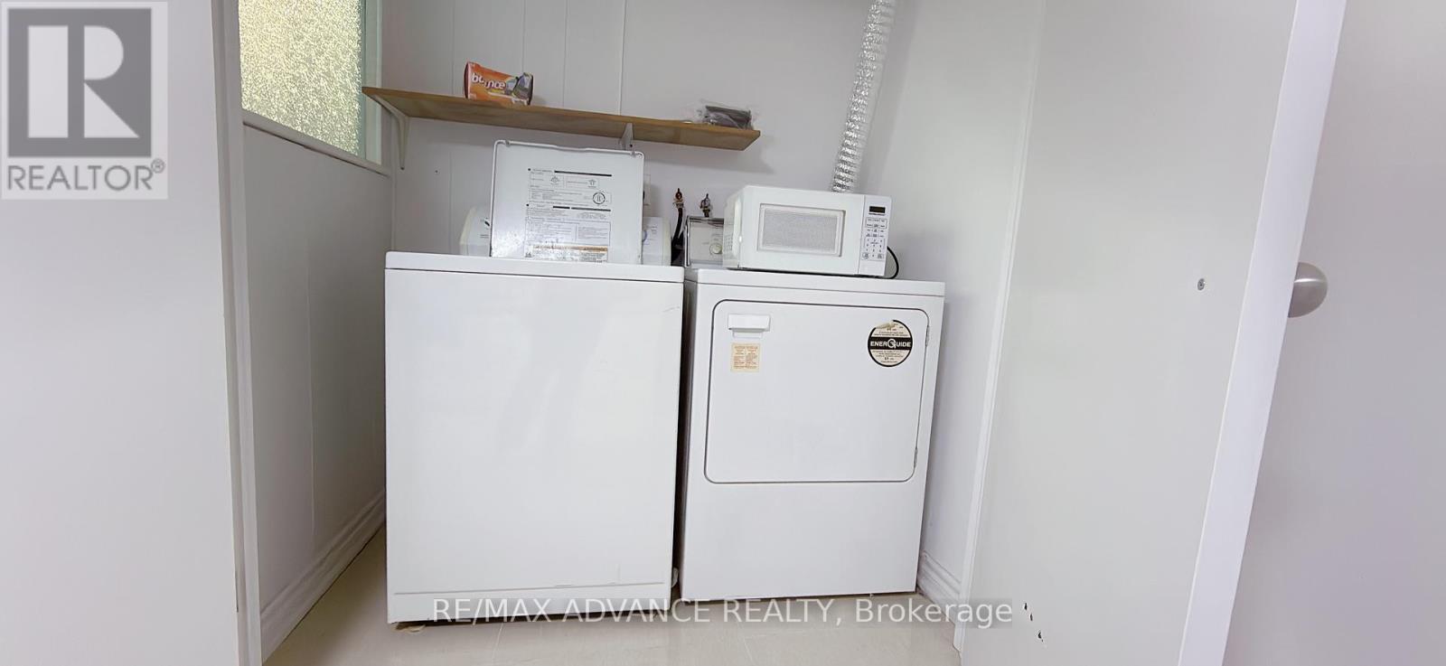 A white fridge and freezer in a small room.