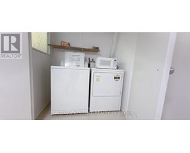A white fridge and freezer in a small room.