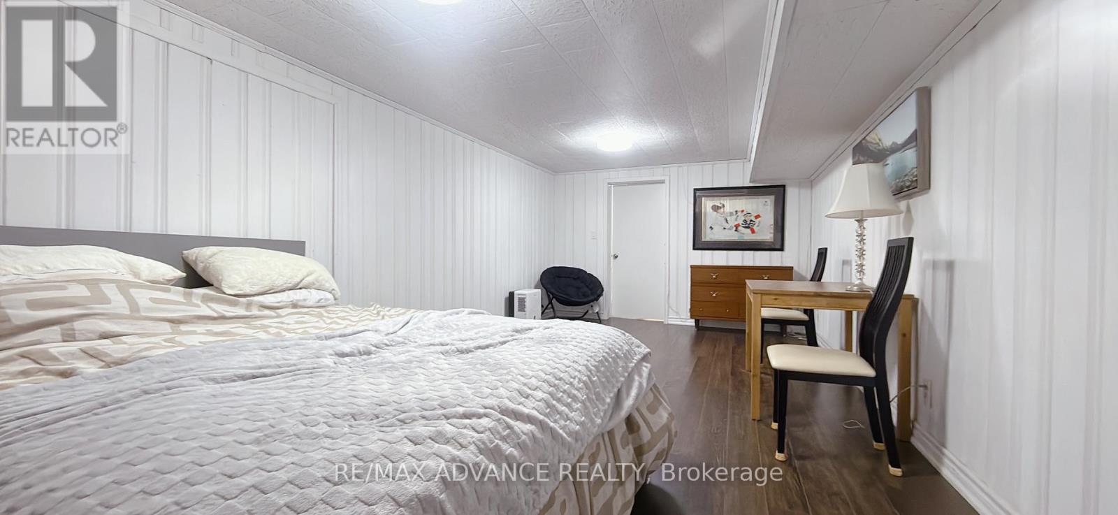 A bedroom with a bed, desk, and chair.