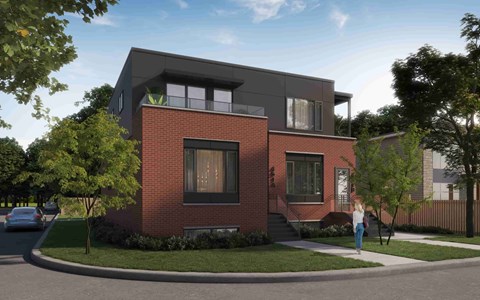 A modern house with a red brick facade and a black upper floor.