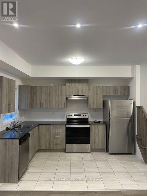 A kitchen with a stove, oven, and refrigerator.