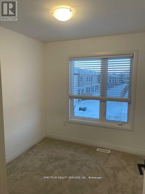 A room with a window showing a view of a building outside.