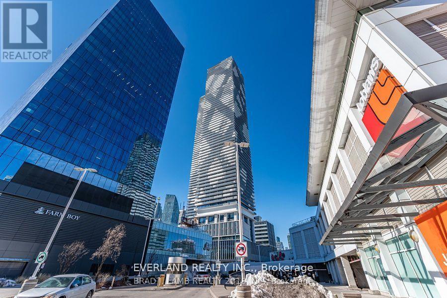 A cityscape with buildings and a sign for Everland Realty Inc.