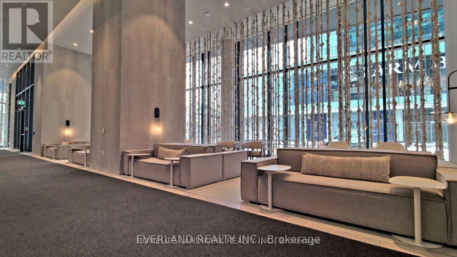 A modern living room with a large window and a couch.