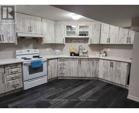 A kitchen with white cabinets and a white stove top oven.