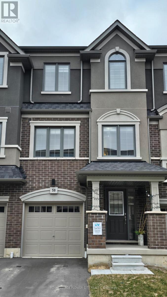 A grey and brown house with a black front door.