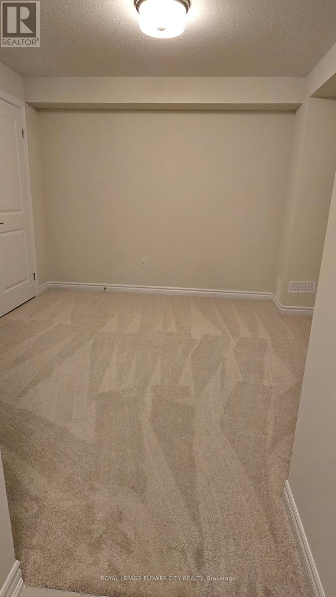 A room with a carpeted floor and a white door.