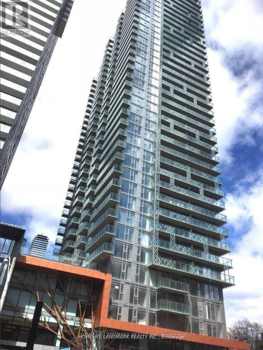 A tall building with many windows and balconies is under construction.