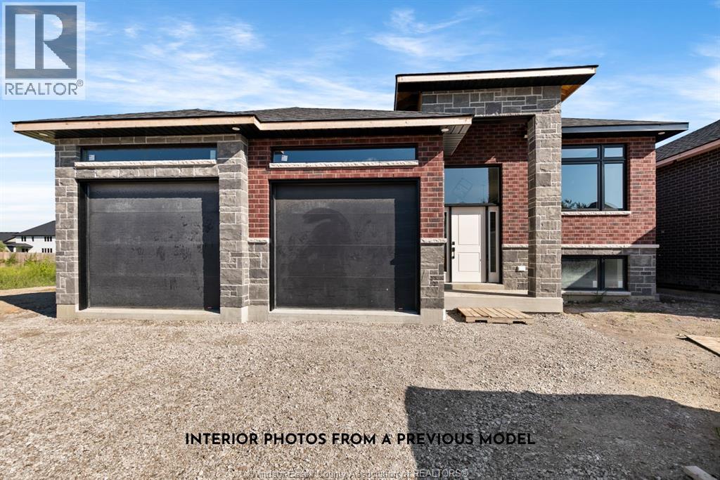 A house with a brick facade and two garage doors is shown.