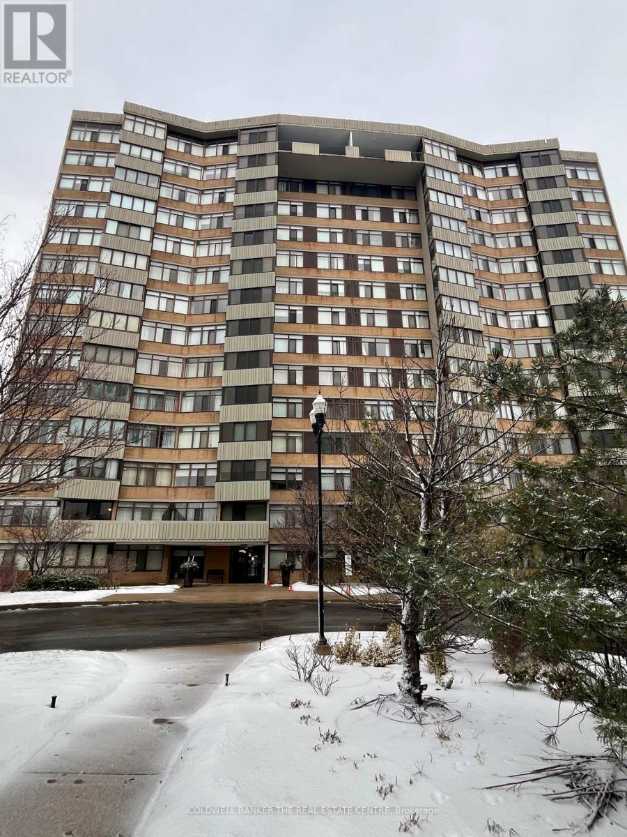A tall residential building with many windows and balconies.