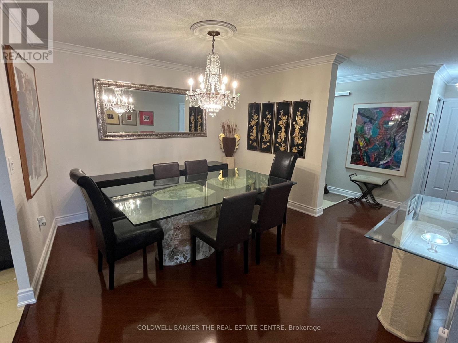 A dining room with a glass table and chairs.