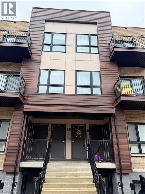 A brown building with a black door and windows.