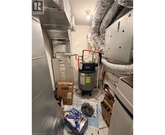 A room with a lot of boxes and a HVAC unit.