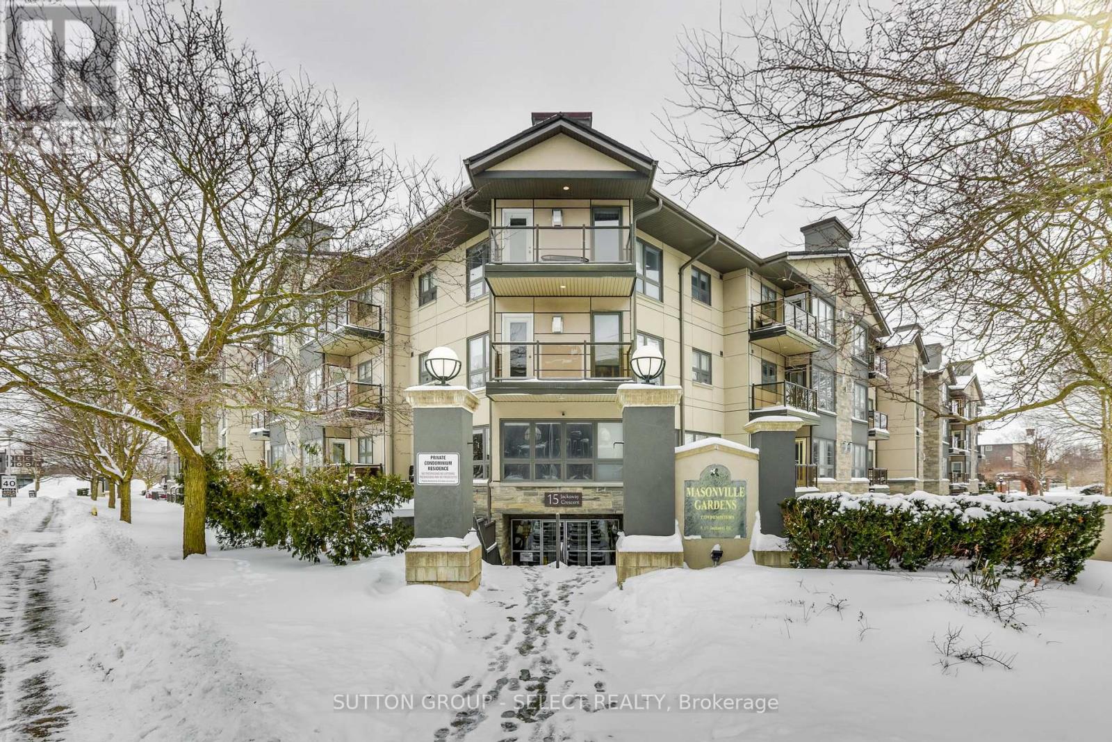 A snow-covered building with a sign that reads "Sutton Grove Estate Agents, Brokerage".