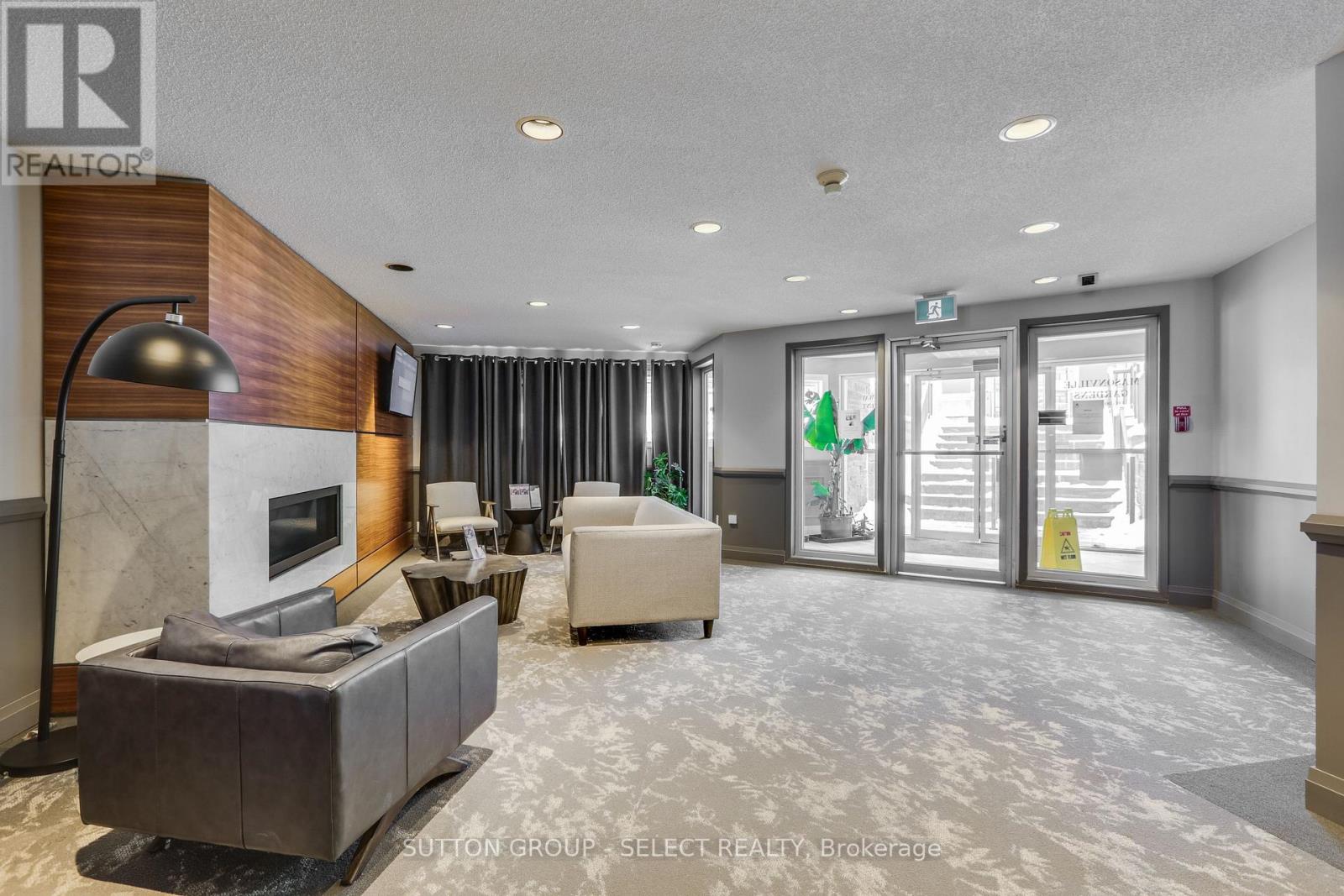 A modern living room with a fireplace and a couch.