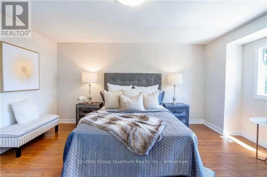 A bedroom with a bed, nightstands, and a bench.