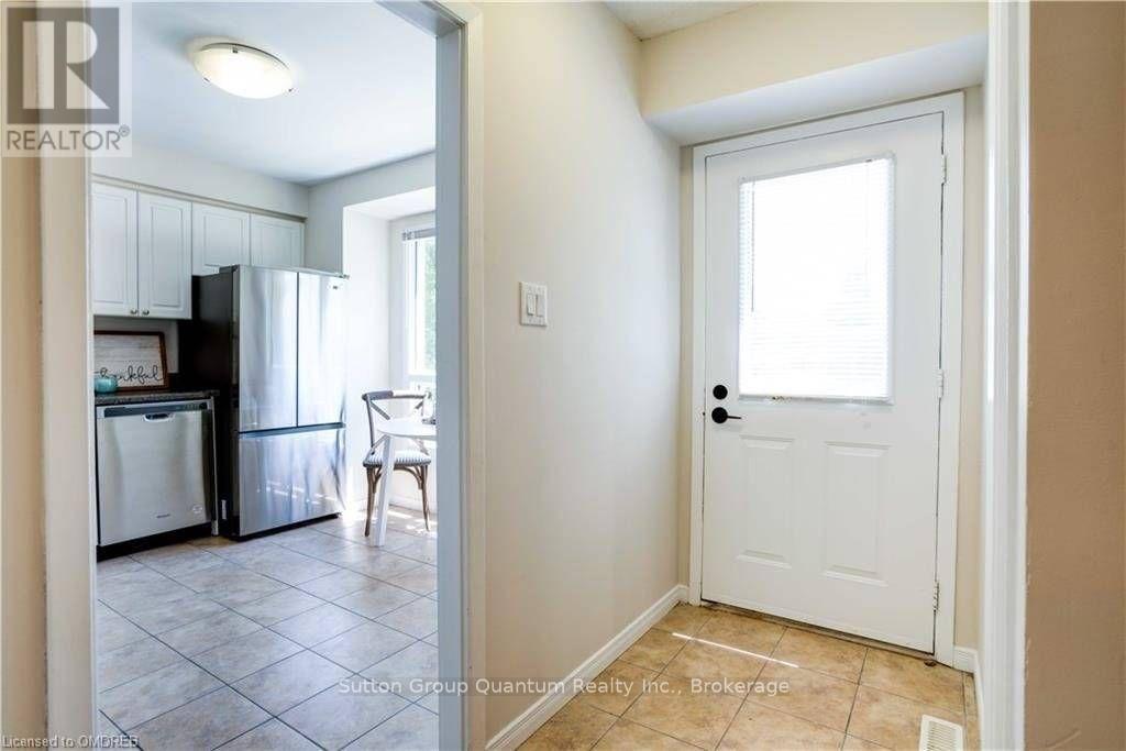 A kitchen with a fridge, dishwasher and a dining table.