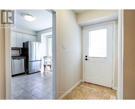 A kitchen with a fridge, dishwasher and a dining table.
