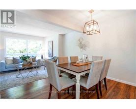 A dining room with a table set for six.