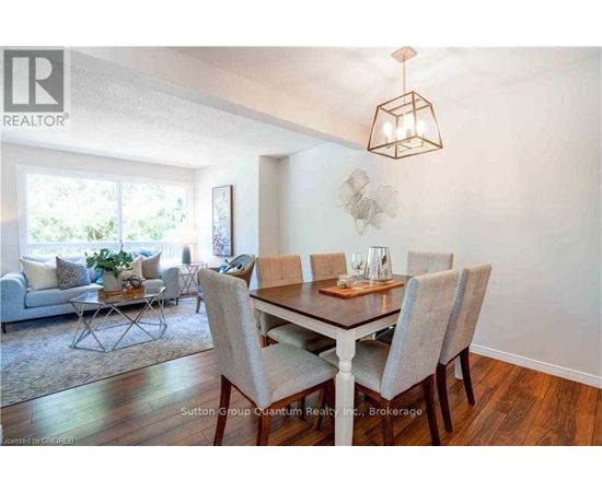 A dining room with a table set for six.