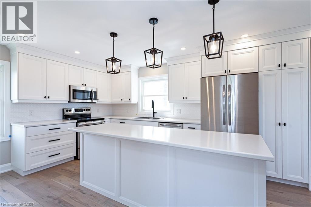 A modern kitchen with white cabinets and a central island.