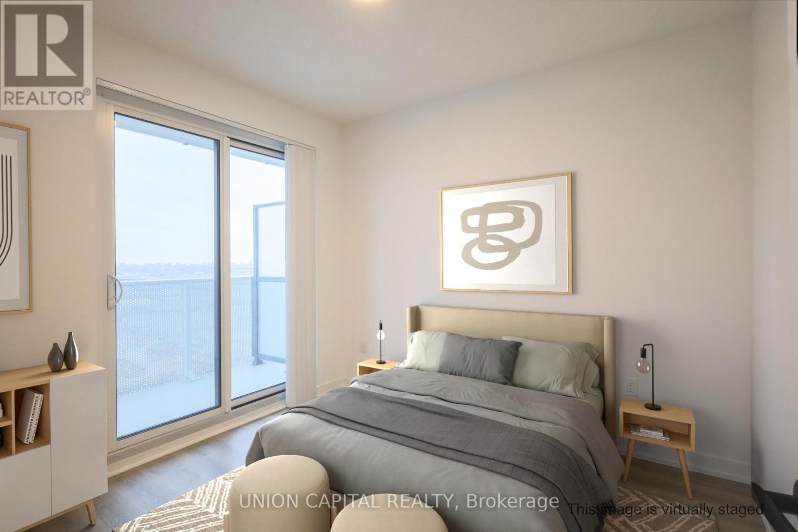 A bedroom with a large bed and a large window overlooking the city.