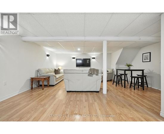 A living room with a white couch and a television.