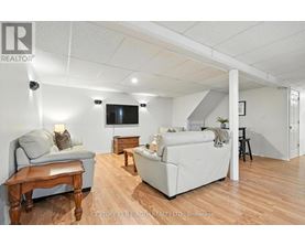 A living room with a grey couch, a white couch, and a wooden table.