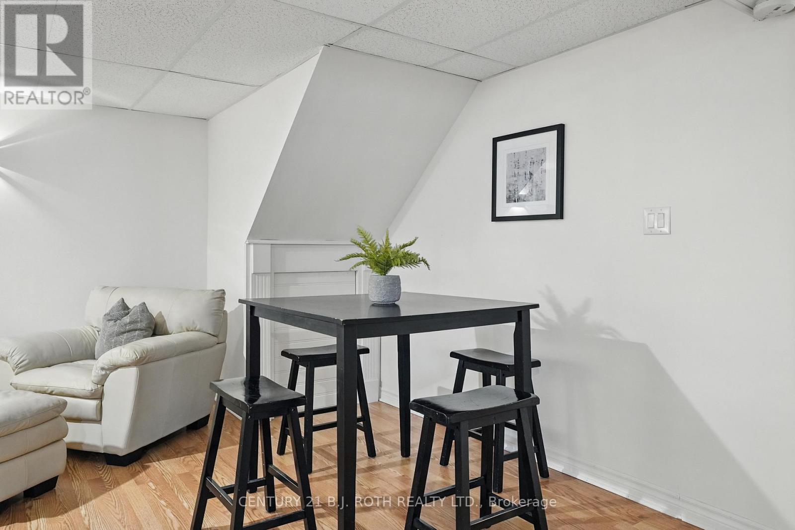 A dining area with a table and chairs.