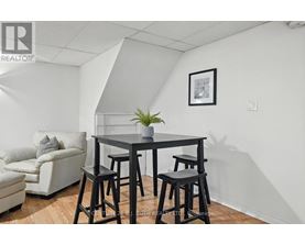A dining area with a table and chairs.