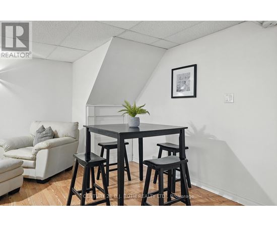 A dining area with a table and chairs.
