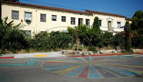 A colorful painted circle in the middle of a street.