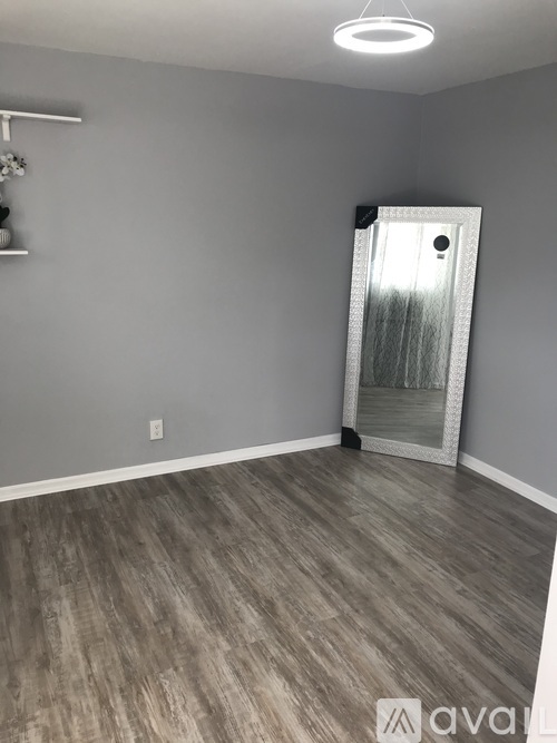 A room with grey walls and wooden flooring.