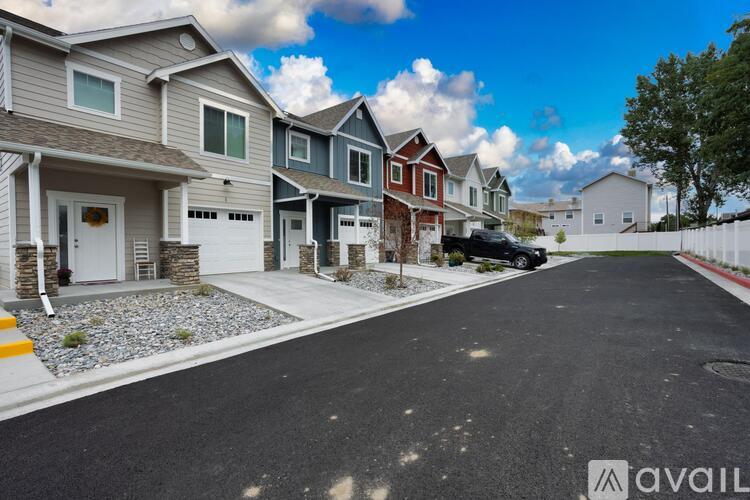 A row of houses with a car parked on the street.
