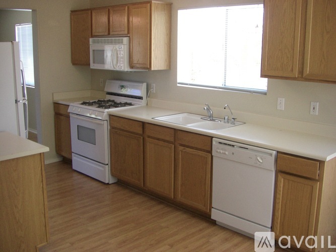 A kitchen with wooden cabinets and white appliances.